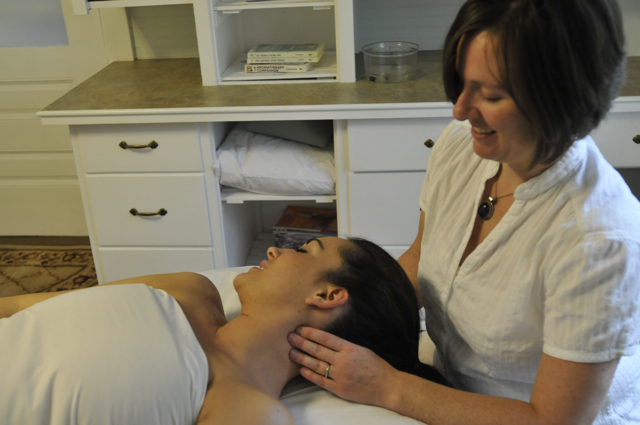 Emily Bilodeau giving a client a neck massage